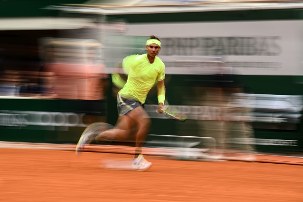 TOPSHOT - Spain's Rafael Nadal returns the ball to Austria's Dominic Thiem during their men's singles final match, on day fifteen of The Roland Garros 2019 French Open tennis tournament in Paris on June 9, 2019. (Photo by Martin BUREAU / AFP)        (Photo credit should read MARTIN BUREAU/AFP/Getty Images)