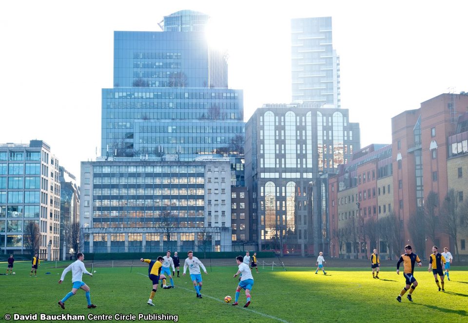 The Honourable Artillery Company Football Club plays against a backdrop of the City of London's distinctive skyline.