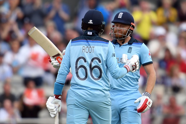 England's Jonny Bairstow (R) celebrates his half-century with England's Joe Root during the 2019 Cricket World Cup group stage match between England and Afghanistan at Old Trafford in Manchester, northwest England, on June 18, 2019. (Photo by Dibyangshu SARKAR / AFP) / RESTRICTED TO EDITORIAL USE (Photo credit should read DIBYANGSHU SARKAR/AFP/Getty Images)