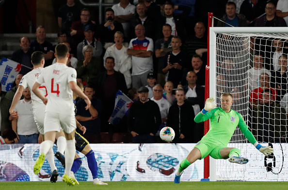 England's goalkeeper Jordan Pickford (R) dives but fails to save a shot from Kosovo's midfielder Valon Berisha (hidden) during the UEFA Euro 2020 qualifying Group A football match between England and Kosovo at St Mary's stadium in Southampton, southern England on September 10, 2019. (Photo by Adrian DENNIS / AFP) / NOT FOR MARKETING OR ADVERTISING USE / RESTRICTED TO EDITORIAL USE        (Photo credit should read ADRIAN DENNIS/AFP/Getty Images)