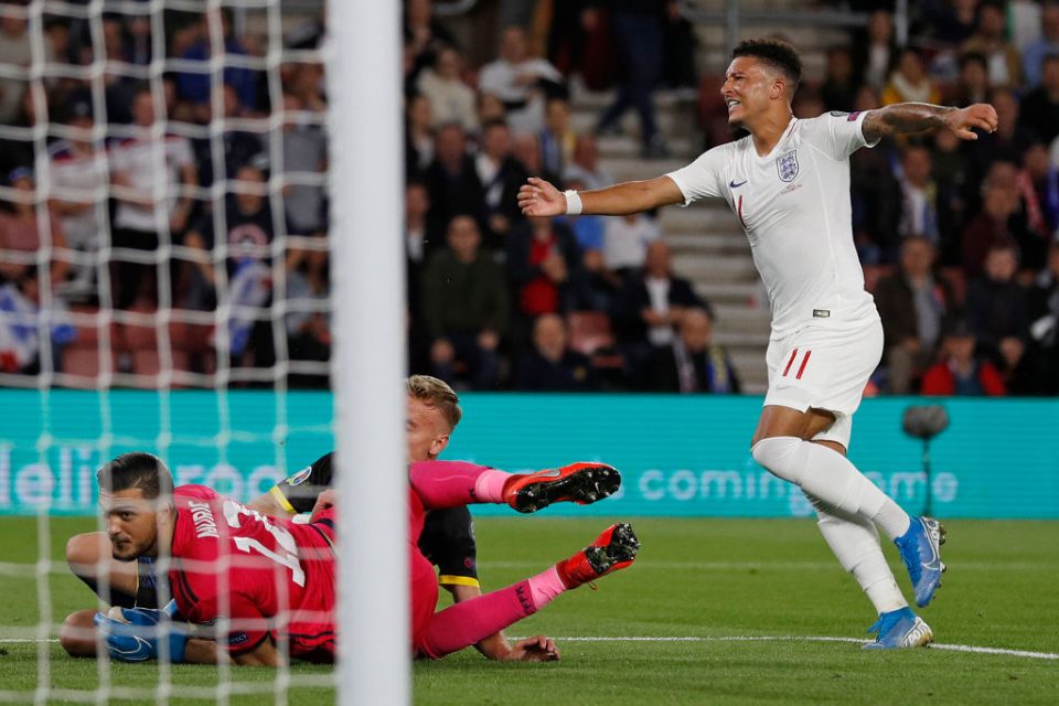 England's midfielder Jadon Sancho (R) celebrates scoring his team's fourth goal during the UEFA Euro 2020 qualifying Group A football match between England and Kosovo at St Mary's stadium in Southampton, southern England on September 10, 2019. (Photo by Adrian DENNIS / AFP) / NOT FOR MARKETING OR ADVERTISING USE / RESTRICTED TO EDITORIAL USE        (Photo credit should read ADRIAN DENNIS/AFP/Getty Images)