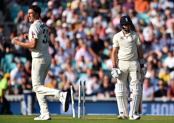 Australia's Pat Cummins (L) celebrates dismissing England's captain Joe Root for 57 runs during play on the first day of the fifth Ashes cricket Test match between England and Australia at The Oval in London on September 12, 2019. (Photo by Glyn KIRK / AFP) / RESTRICTED TO EDITORIAL USE. NO ASSOCIATION WITH DIRECT COMPETITOR OF SPONSOR, PARTNER, OR SUPPLIER OF THE ECB        (Photo credit should read GLYN KIRK/AFP/Getty Images)