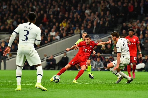 Bayern Munich's Polish forward Robert Lewandowski (C) shoots to score their second goal during the UEFA Champions League Group B football match between Tottenham Hotspur and Bayern Munich at the Tottenham Hotspur Stadium in north London, on October 1, 2019. (Photo by Glyn KIRK / IKIMAGES / AFP)        (Photo credit should read GLYN KIRK/AFP/Getty Images)